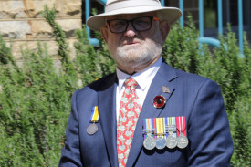 A local veteran reflects during the service.