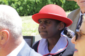 A local school student watches on.