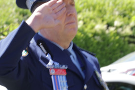 Local police representative Superintendent Brendan Bernie salutes towards the Cenotaph.