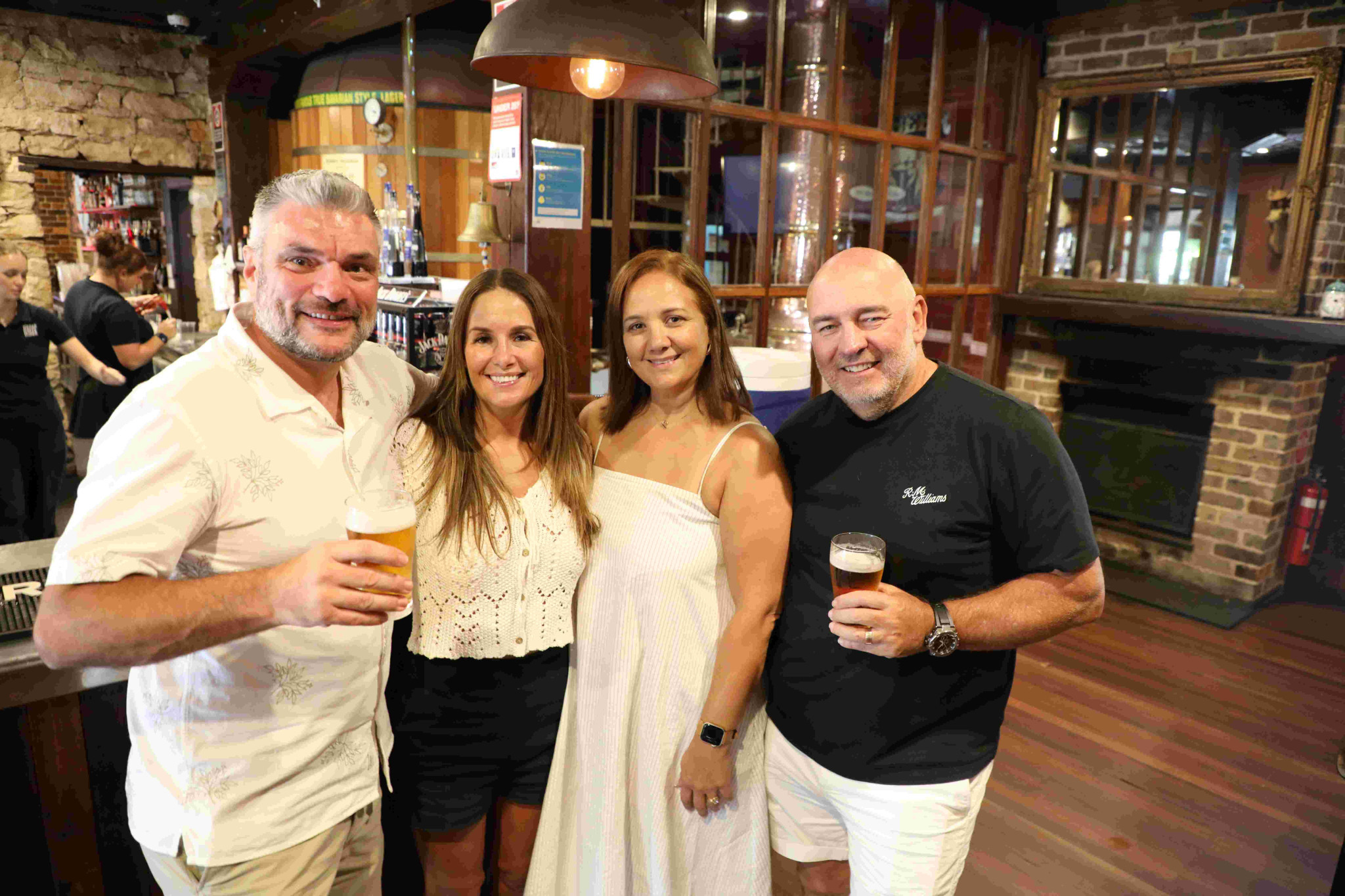 Pub owners Ross Robinson (left) and Adam Cryer (right) with their wives Elly Robinson and Melissa Cryer. Photo Stuart Carless.