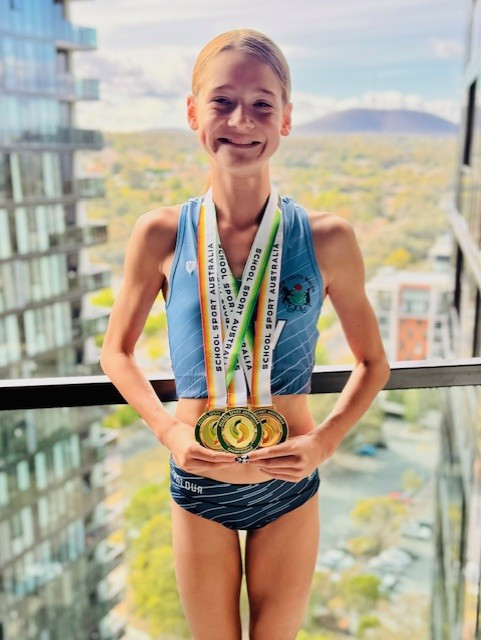 Harlow with her swathe of medals she won. (Supplied)