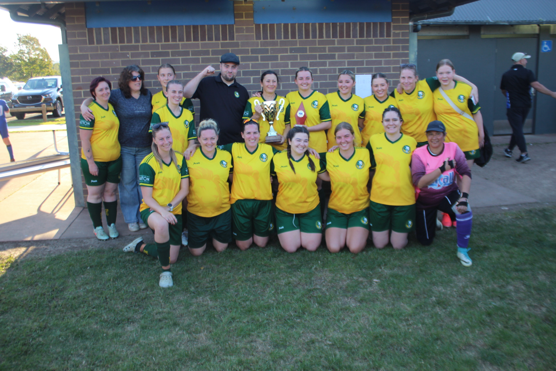 The Mittagong Lionesses celebrate their 4-0 win against Robertson with coach Josh Sloboda (fourth from right).