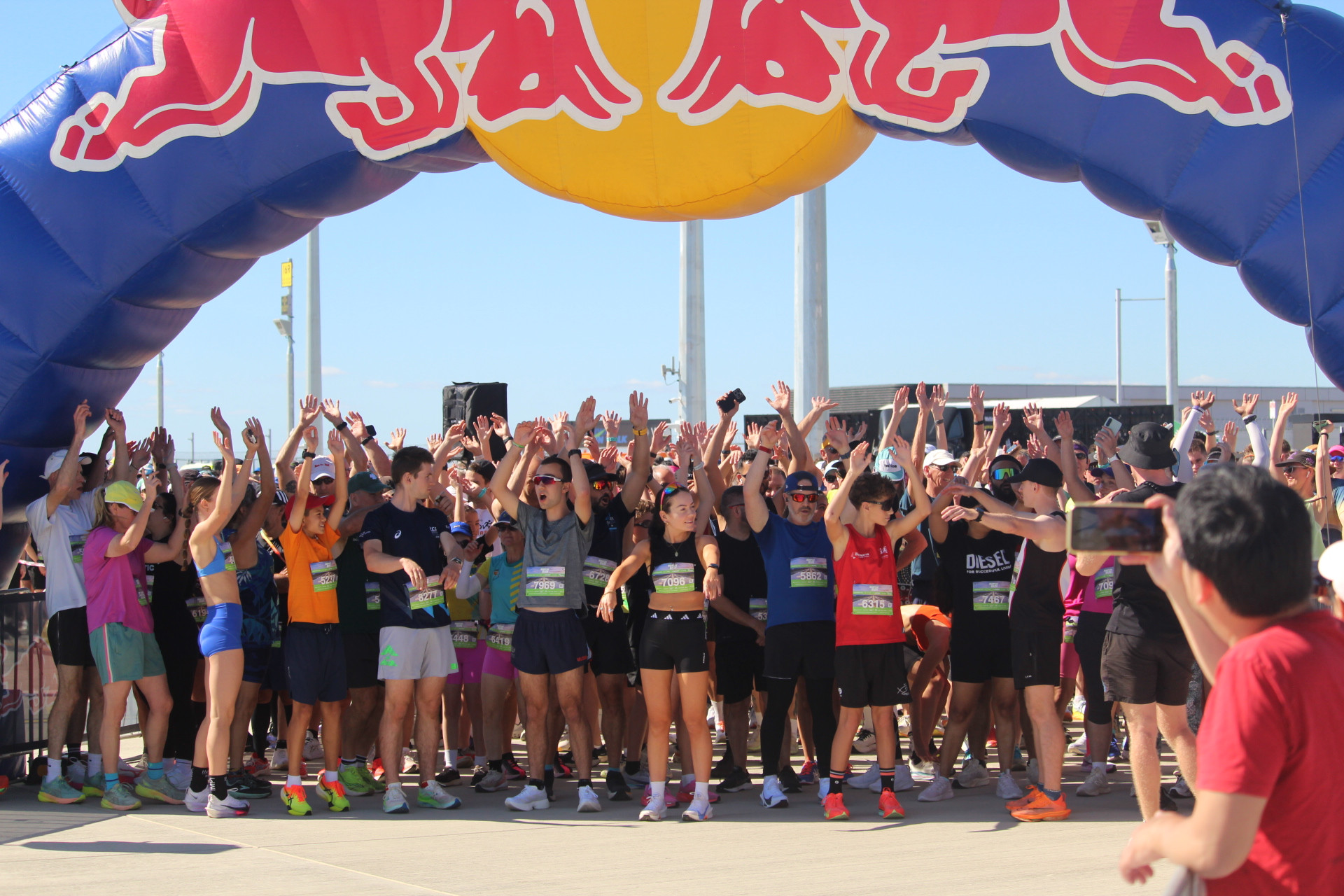 Runners do a ‘Mexican wave in preparation for their event.