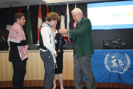 Rotary’s Robert deJongh presents the Oxley College students with their medals for receiving the Rotary Peace Prize.