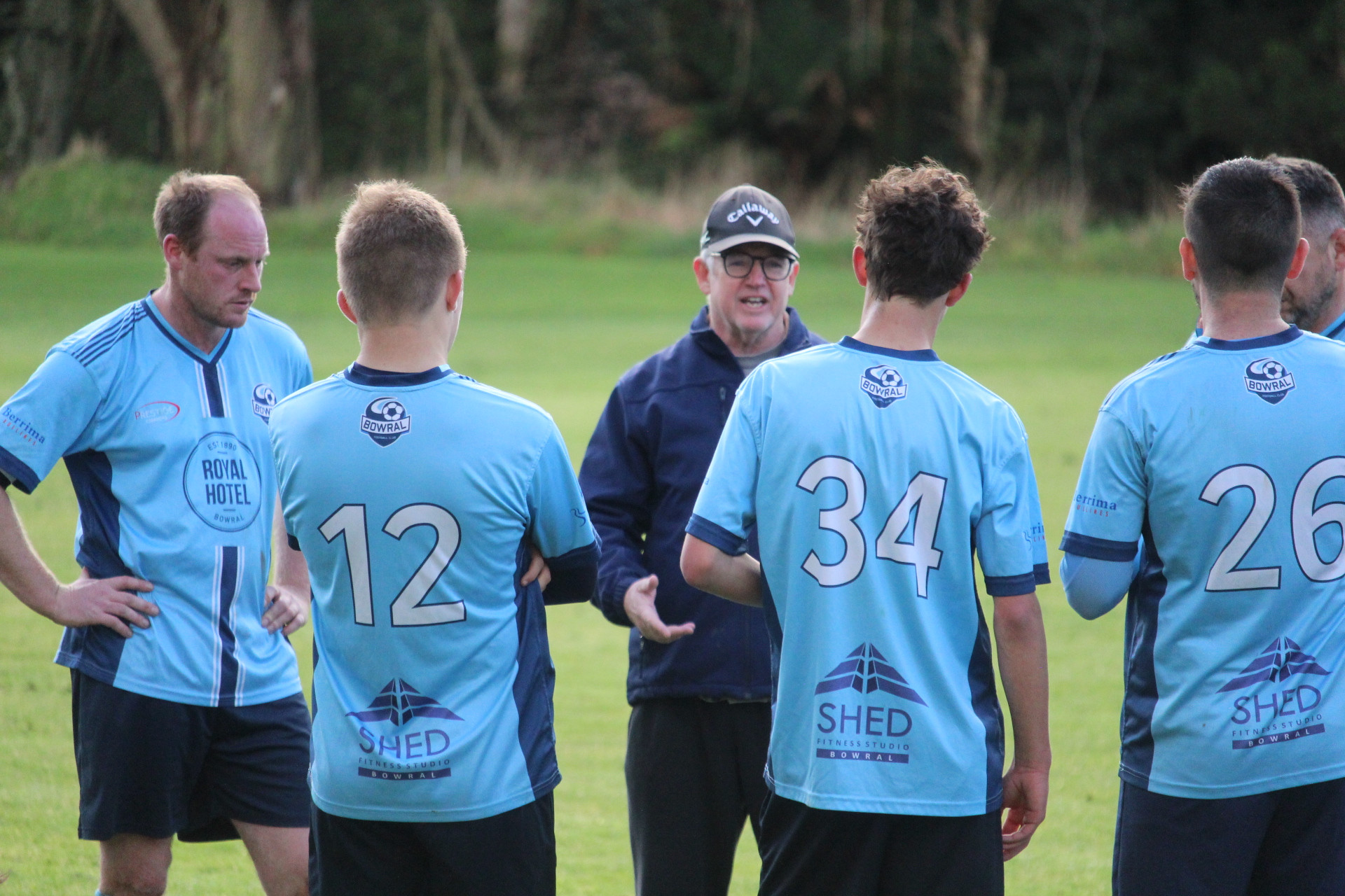 Bowral coach Glenn Shelton gives the players a pep-talk at the half time break.