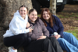 Milli Huleatt (left), Charlotte Morley and Ella Dagna enjoyed watching the match in the sunshine.