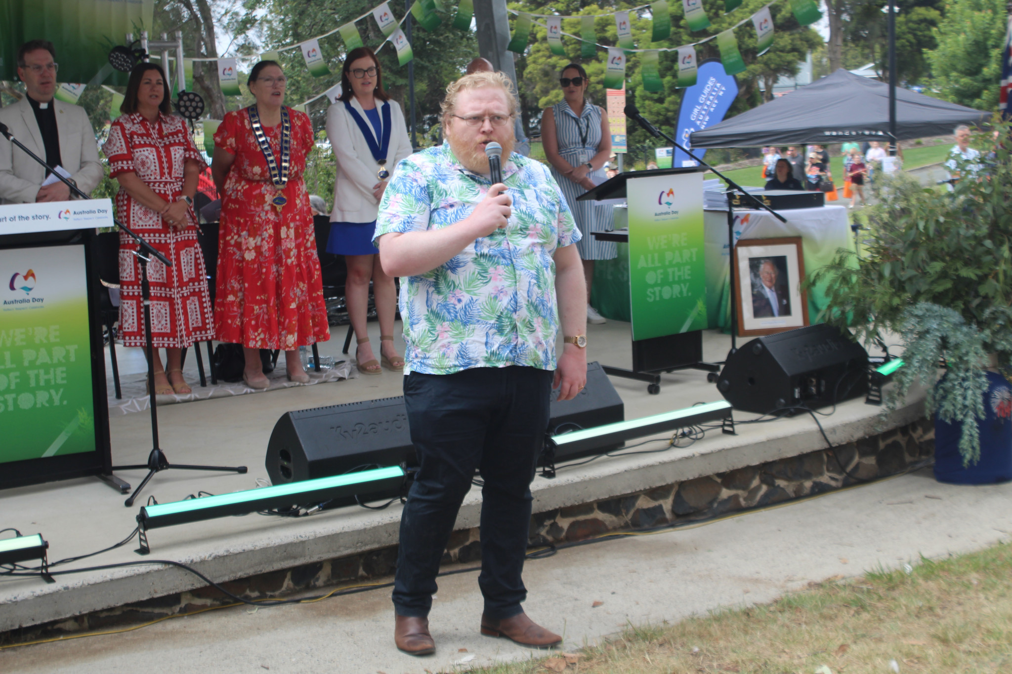 Singer Lachlan McGowan leads the crowd in the singing of the National Anthem.