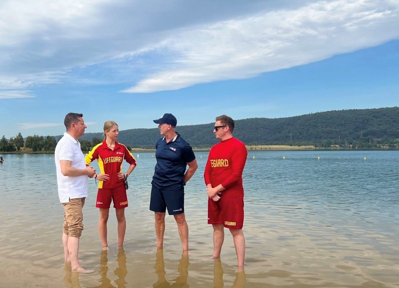 Lifeguards chat to Minister Paul Scully MP in the water. Supplied.