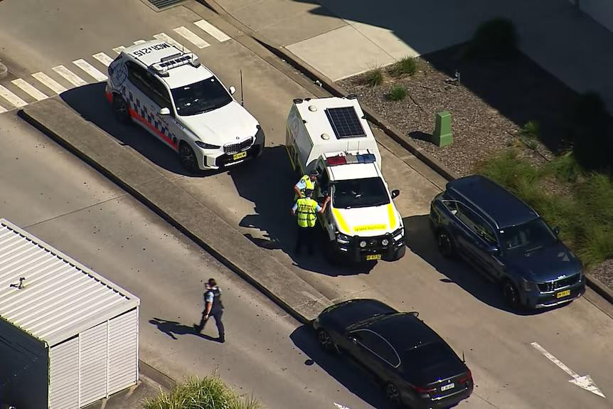 Police swarmed the shopping centre car park after shots were fired at a man by two masked men Photo: ABC News
