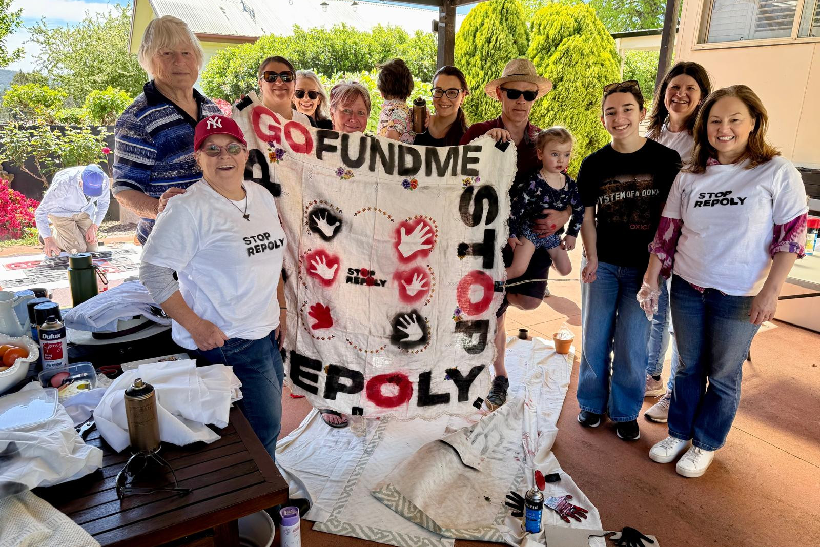 Some of the community who turned bedsheets into banners.
