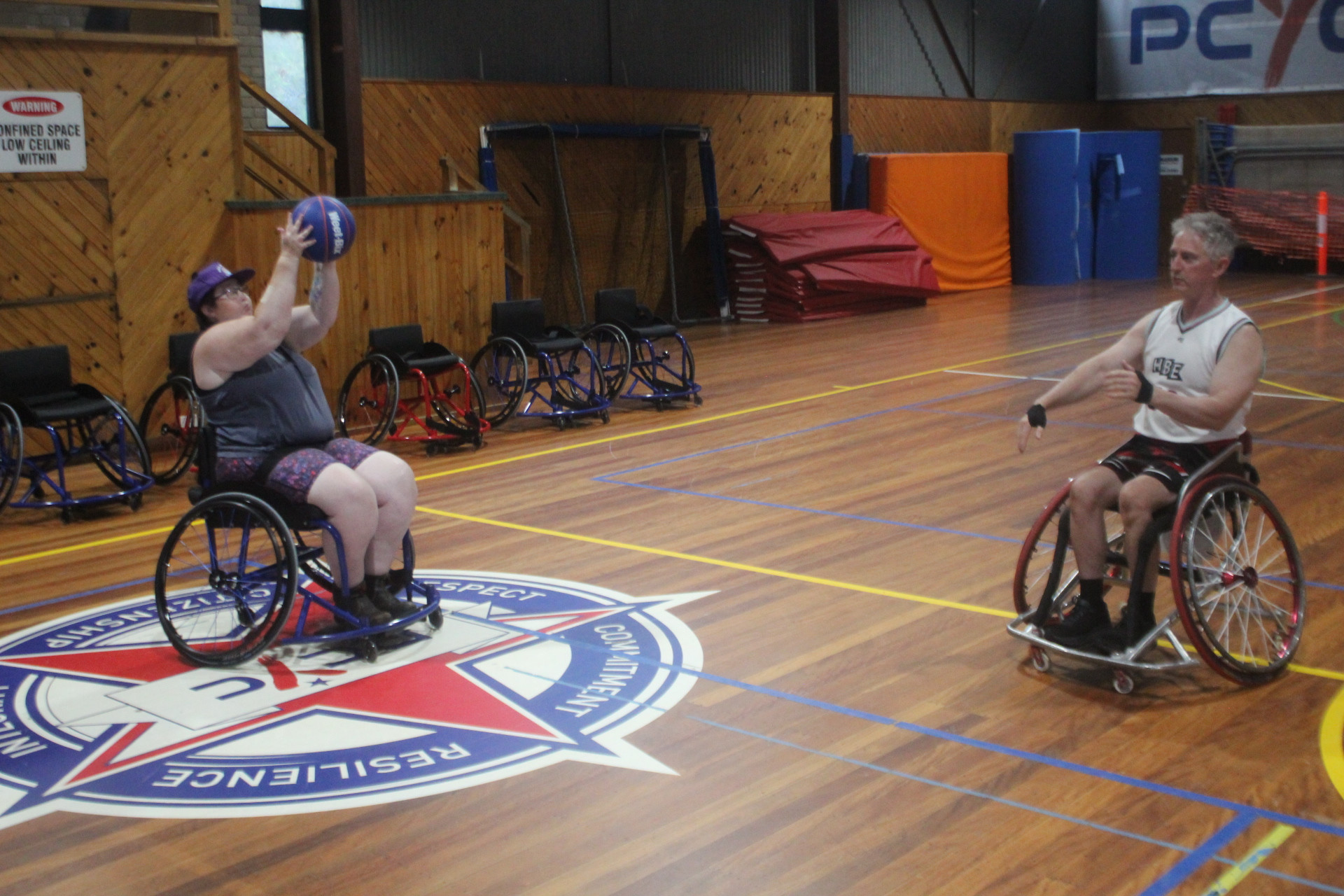 Development Group Leader for the Illawarra Rollerhawks,Brian Gardner (right) demonstrates passing the ball to fellow player, Mandie Young. (Photo: Antony Dubber)