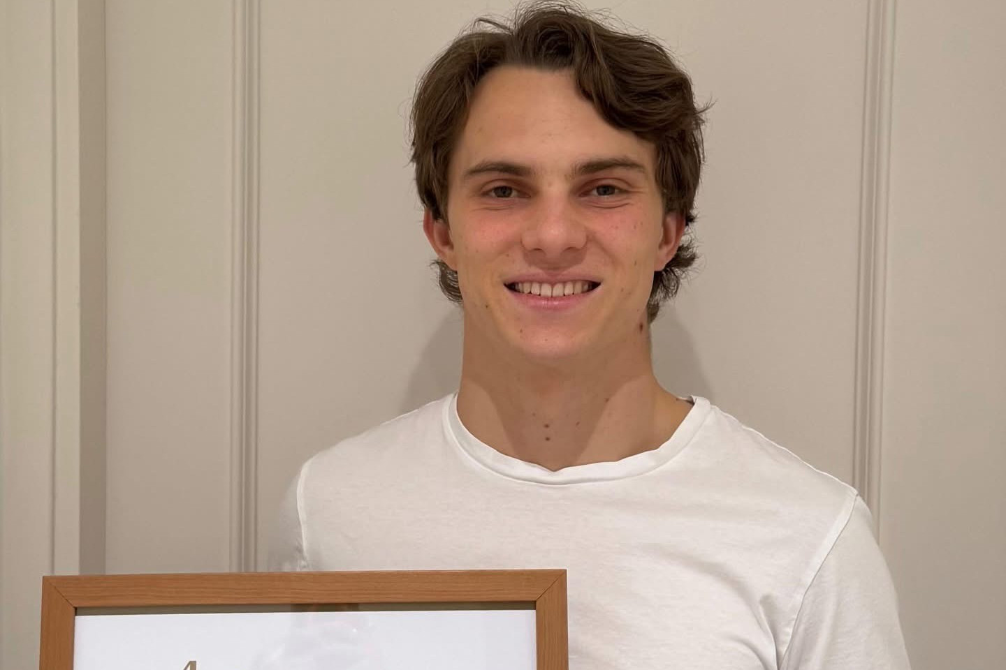 Oscar Piastri proudly holding his 'Don'award certificate. Supplied.