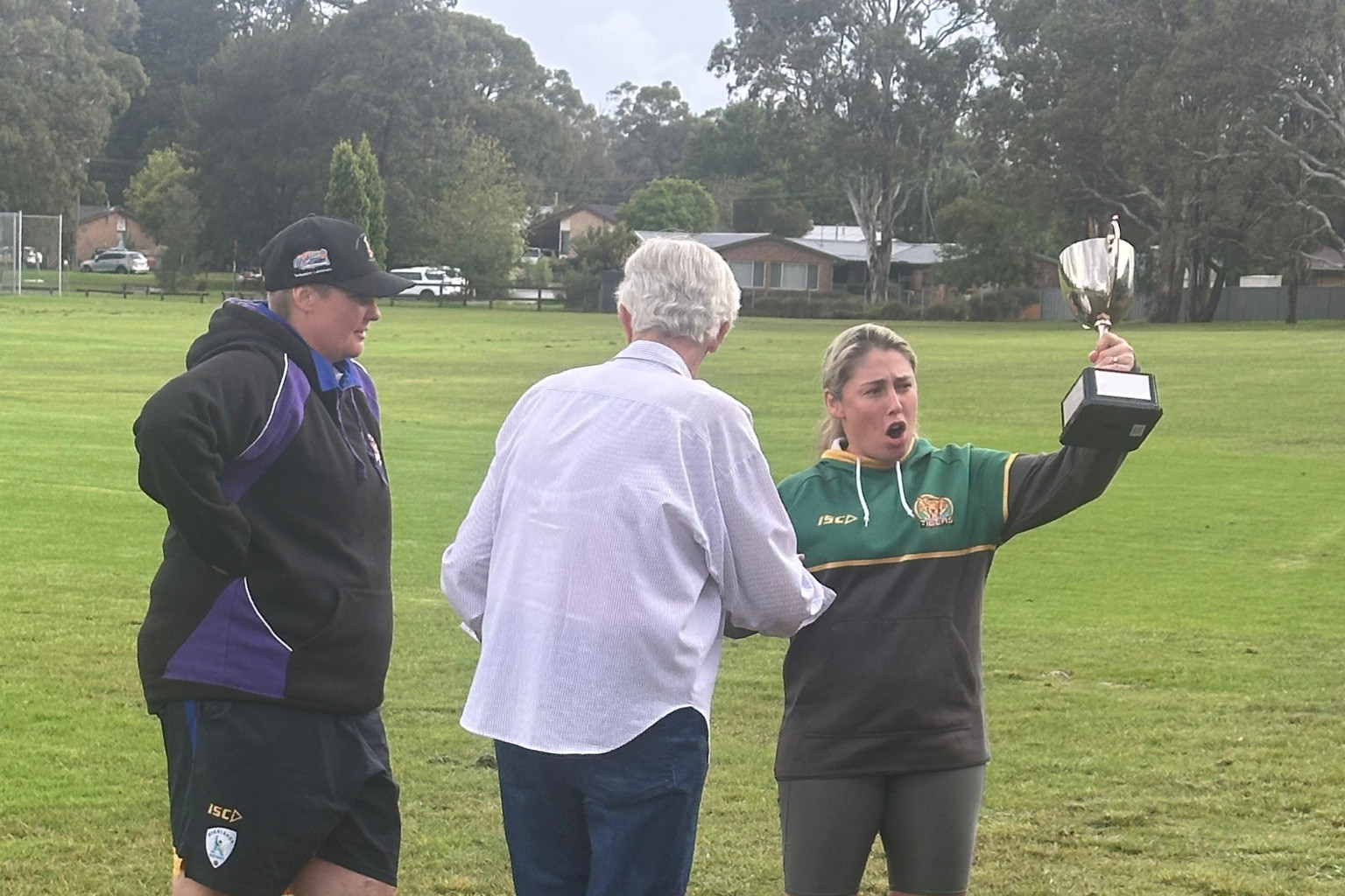 The Wingello captain accepts the trophy from Tina Macpherson, with Highlands women's cricket director Jen Kitchen watching on.