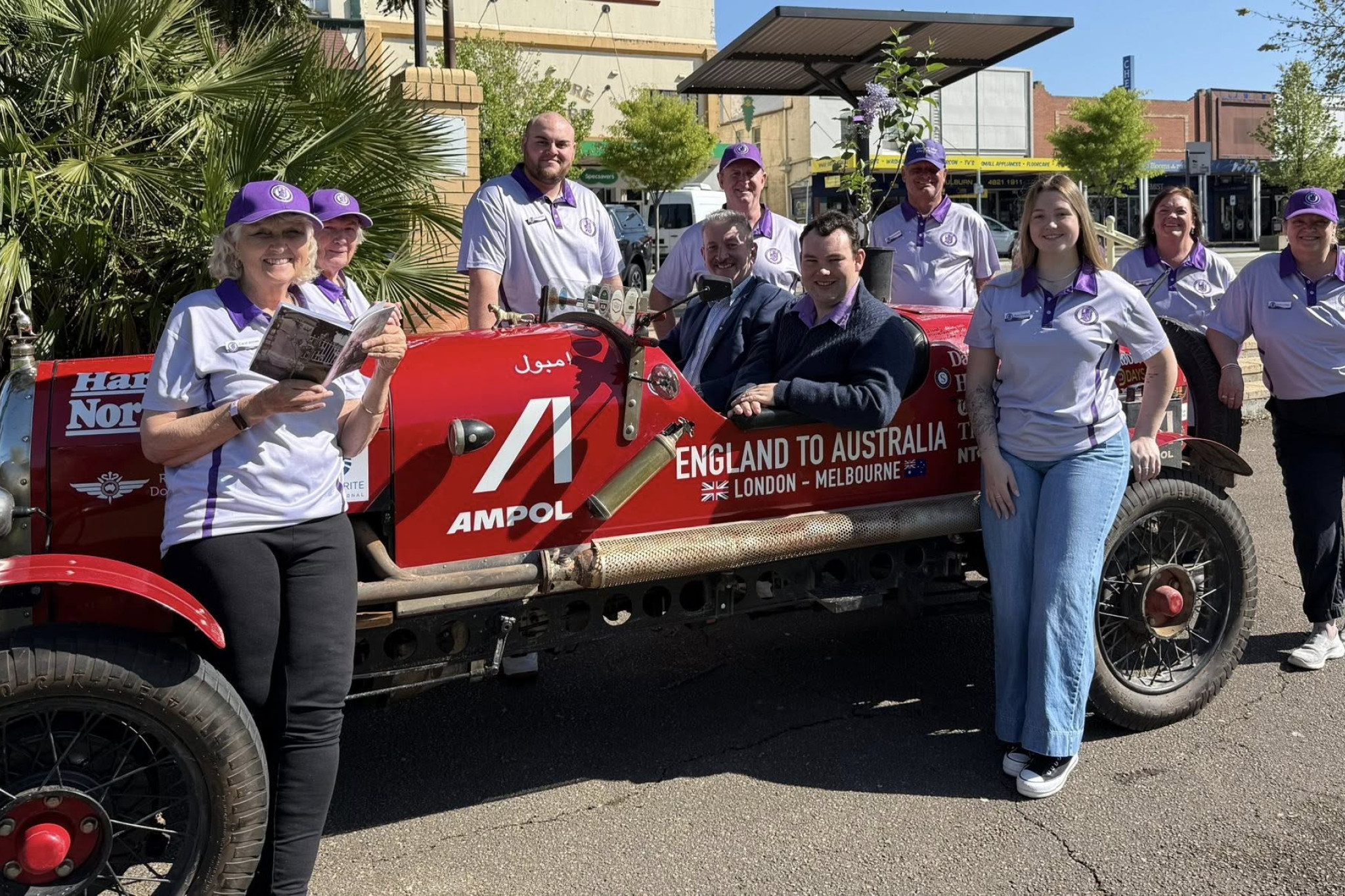 Newspaper cartoonist Warren Brown (pictured centre at the wheel with the Goulburn Lilac City Festival 2025 Committee) in his 1925 Bean 14 Sundowner which will be a part of the Lilac Festival festivities this October long weekend. (Photo: supplied)