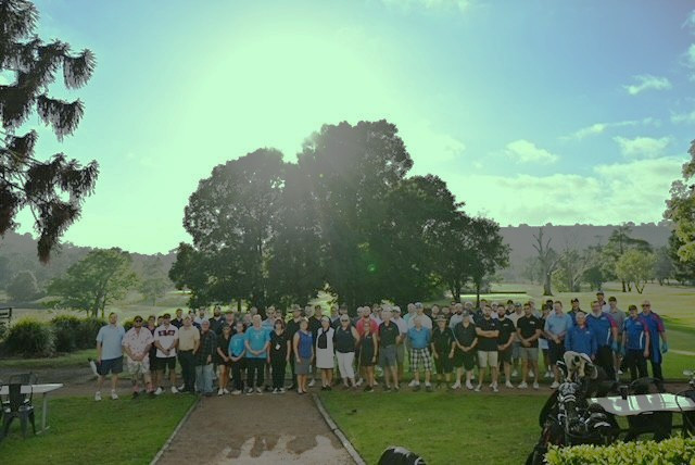 All the teams gathered on the greens for a group photo in very bright and sunny conditions.